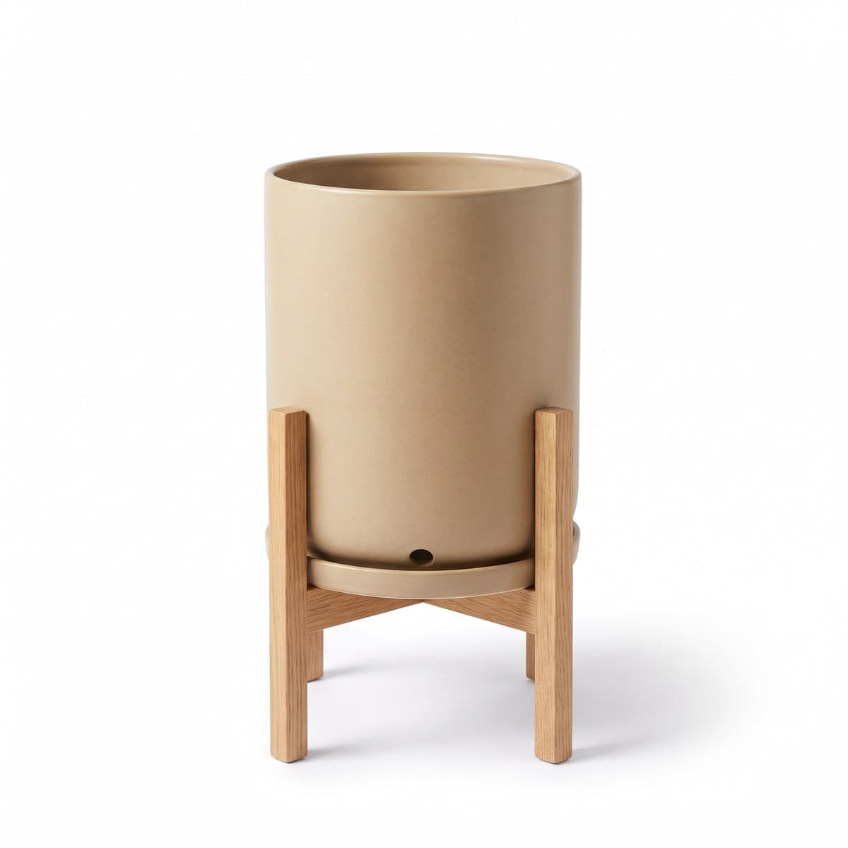 A tall round sand-glazed ceramic floor planter with a saucer, set in a three-legged wooden stand